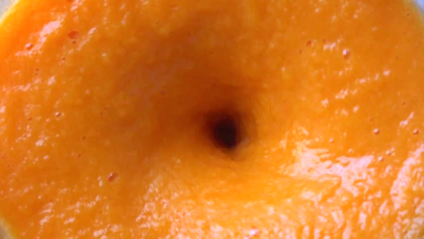 Slow motion close up shot of orange smoothie being made in a blenter. Top view Royalty-Free Stock Footage #17647438