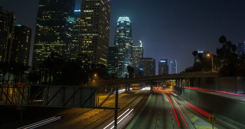 Los Angeles, California, USA - Light trails of passing cars at Freeway 110 - view from Bridge 3rd St. at Financial District facing southwest at night - Timelapse with pan left to right - August 2013