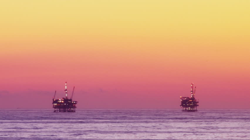 Ocean Sunset - Oil Rig Drilling Platforms on Horizon
