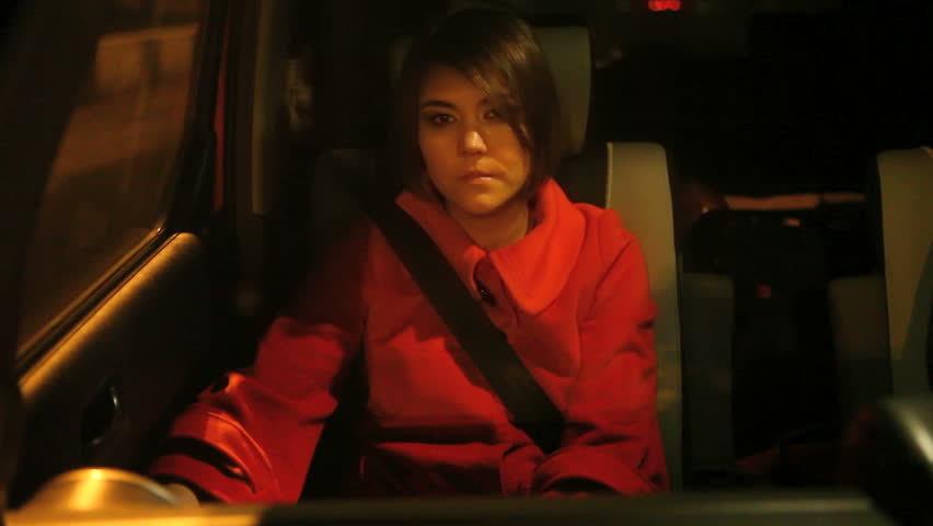 young woman in passenger seat of moving car