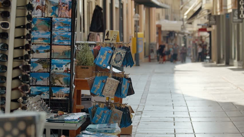 Shopping street in the Greece. Defocuse tourists with different activities.