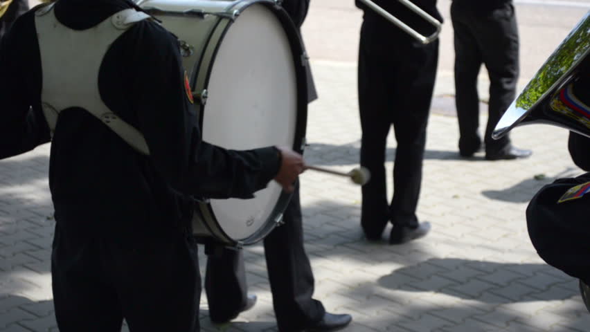 Military navy band drummer playing bass drum
