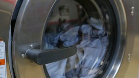 Washing machine at laundromat shop in 4k UHD video.