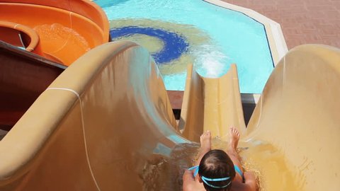 Young Boy Riding On Orange Water Slide To The Pool. Aquapark, Water Park, Holidays, Hotel, Happiness, Summer. HD, Size: 1080p (1920x1080), Sound: No