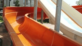 Young Man and Little Boy Riding On Orange Water Slide To Pool. Dad, Father and son ride water slide. HD, Size: 1080p (1920x1080), Sound: No 