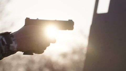 Gun training pistol detail filmed at sunset in native slow motion scene - Slog 3 color science