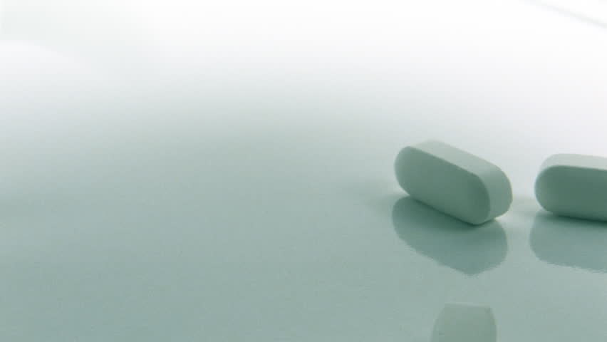 Vitamin Pills Falling on White
