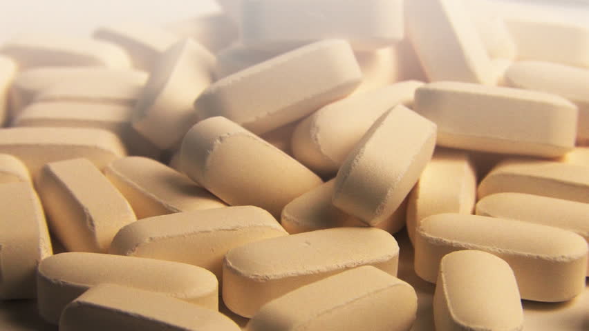 Vitamin Pills Rotating on White