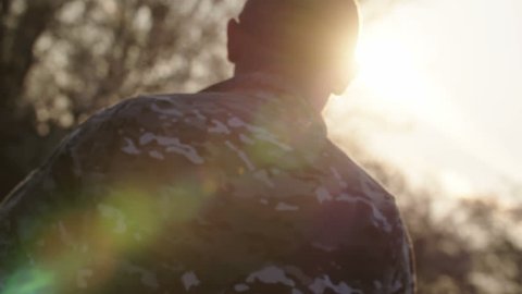 Army soldier walking confident in sunset scene - force diagonal shot