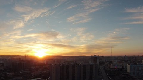 sunset over the city of Yakutsk Russian Republic of Sakha Yakutia in 2016 June. view from the roof of the city under the setting sun taymlaps clouds