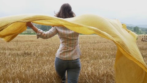 Beautiful girl young attractive woman wheat field happy portrait scarf flying in the wind smile  slow motion happy emotion healthy and natural background slowmo