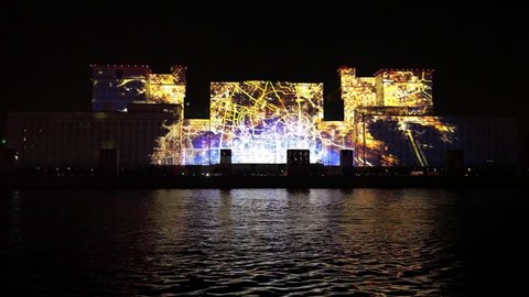 MOSCOW, RUSSIA - OCTOBER 02, 2015: International Festival "Circle of Light". Laser video mapping show on facade of the Ministry of Defense in Moscow, Russia. 3D projection mapping on building