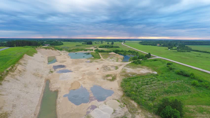 Open mine / quarry. Aerial view. Nature landscape. Massive clouds.