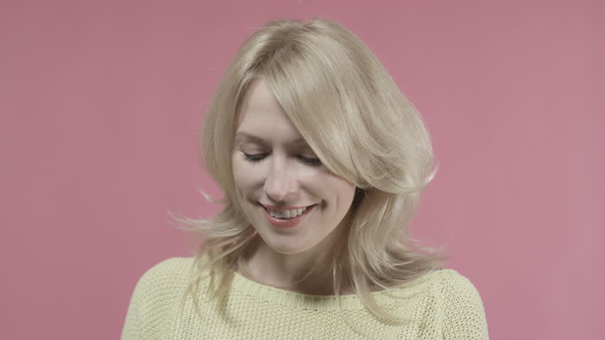 Blonde girl licking her fingers and lips