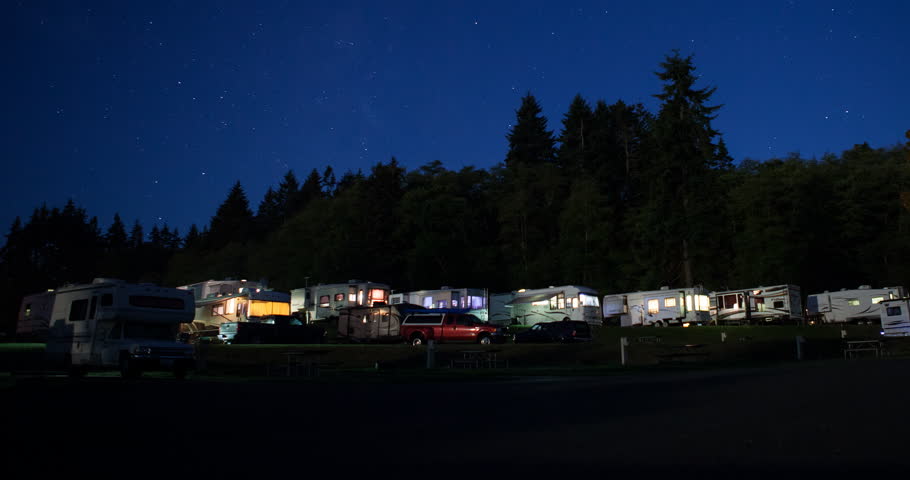 Tongue Point, Washington, USA - starry night with moonlight on the campground with illuminated camper vans - Timelapse with pan left to right - October 2014