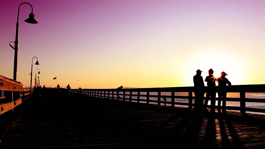 People on Pier Silhouette at Sunset