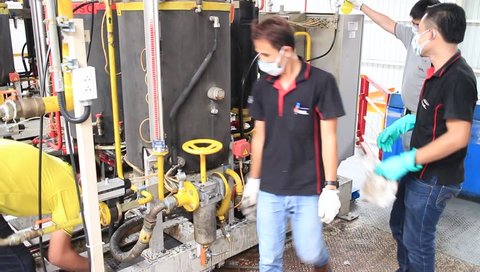 Rayong Plant - Thailand , June 29 - 2016 : Operator in factory cleaning machine in production line for 5S activity every week at Thailand 