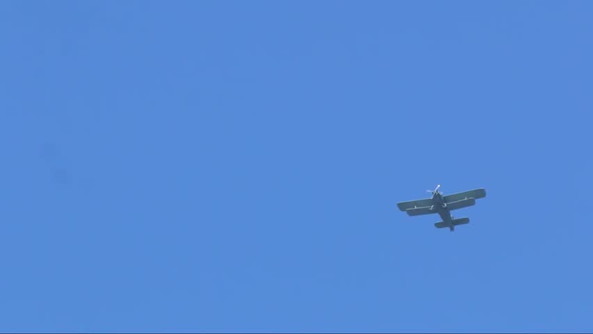 helicopter flies against the blue sky 