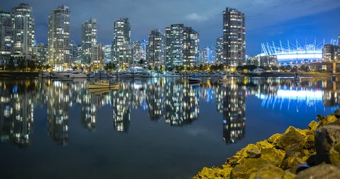 Vancouver, British Columbia, Canada - view over False Creek, Quayside Marina, Cambie Street Bridge and illuminated BC Place Stadium at night - Timelapse with pan right to left - October 2014