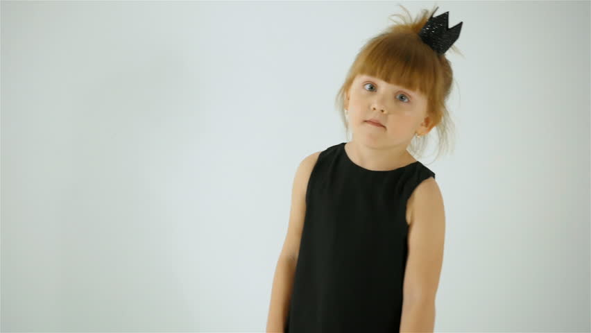 Cute Little Girl In Black Dress Dancing And Having Fun, Isolated On White