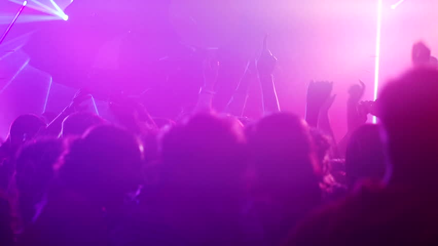 Nightclub party clubbers with hands in air