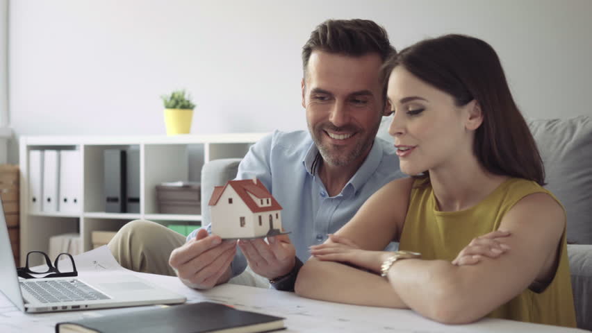 Happy couple talking about new home design