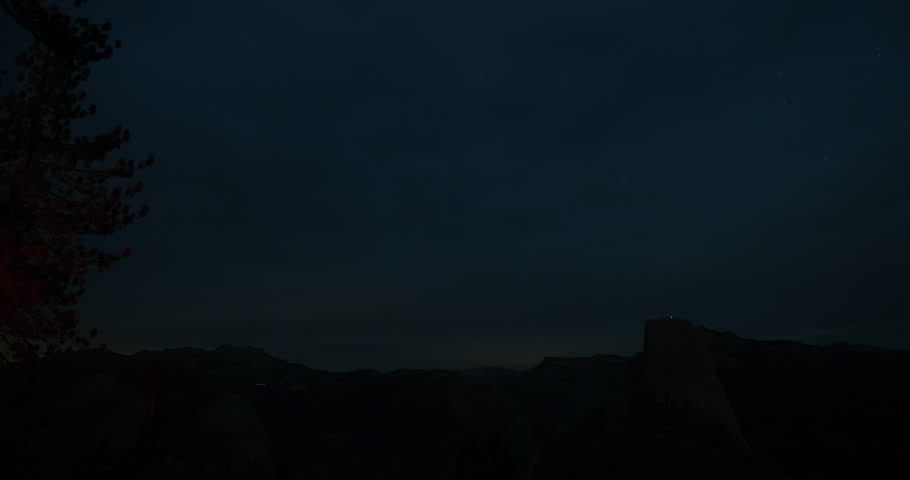 Yosemite National Park, California, USA - panorama view of Half Dome from Washburn Point in the dark of the night with stars - Timelapse with zoom out - October 2014