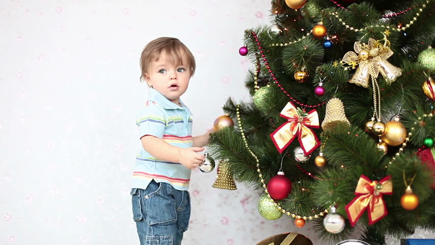 Baby boy near a Christmas tree