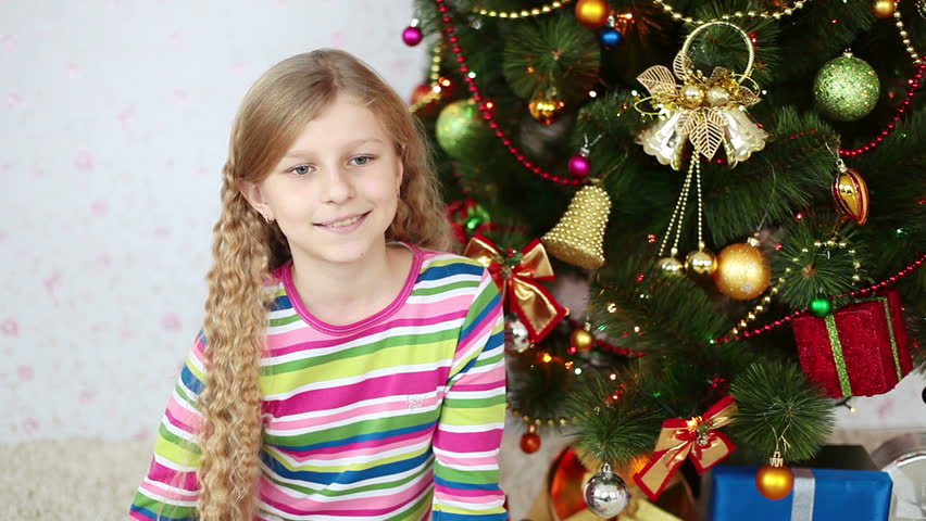 The girl gave a gift and looking at camera
