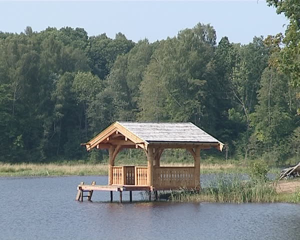 A small wooden house on the lake. Summerhouse outdoor recreation. 