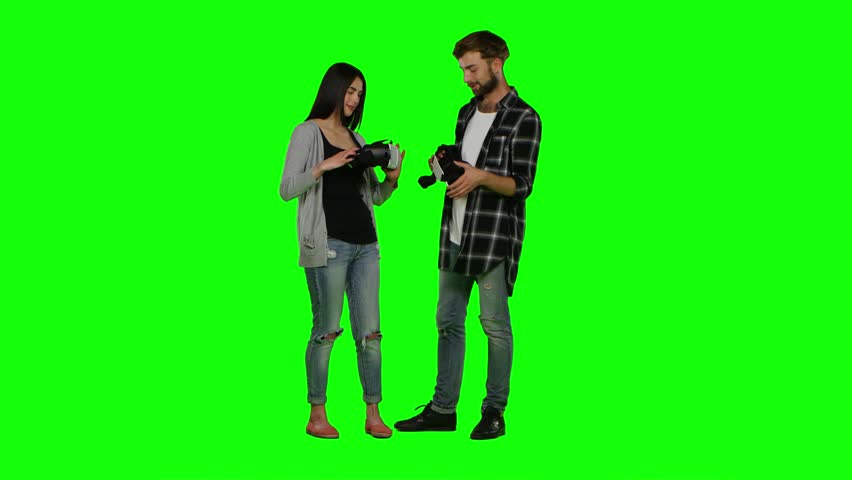 Surprised couple plays some virtual reality games. Green screen