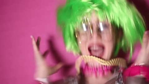 Crazy and angry girl wearing green wig and weird glasses