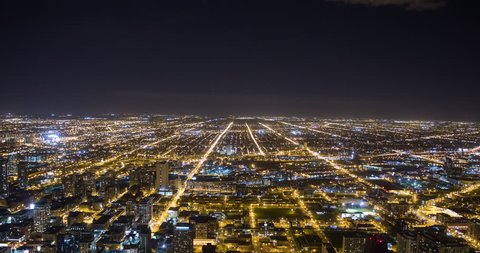Chicago, Illinois, USA - view from the observatory of illuminated City facing west at night - Timelapse with zoom out