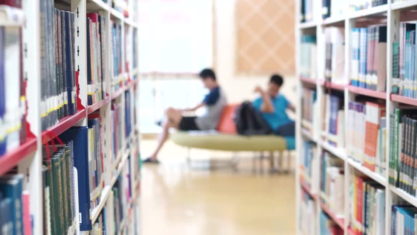 Bookshelf in Library people reading