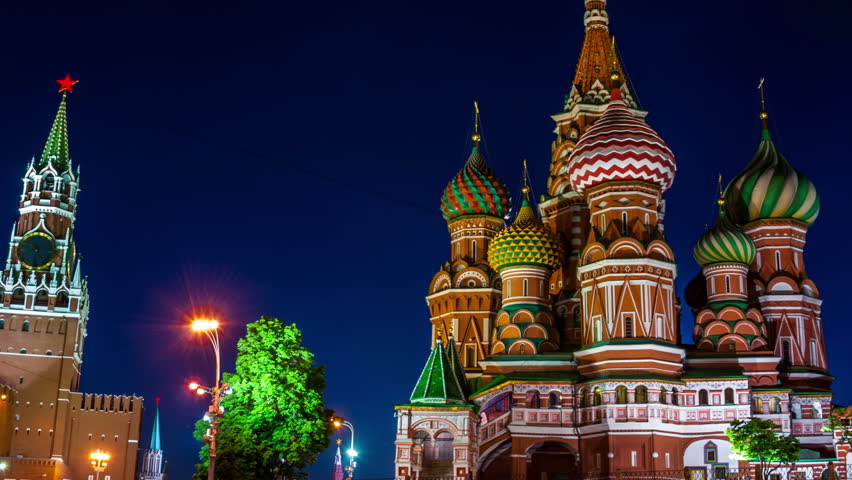 Time-lapse. Saint Basil Cathedral on Red Square at night with Kremlin Tower, Moscow. One of the most popular landmark in Russia. The building is shaped as a flame of a bonfire rising into the sky