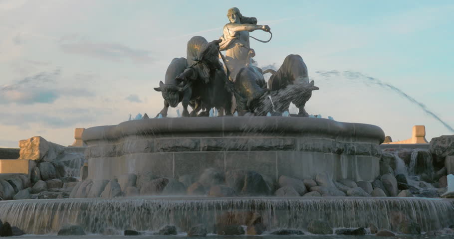 View to the famous Copenhagen landmark. The Gefion Fountain with statue of Norse goddess Gefjun driving bulls, water flowing down on the stones