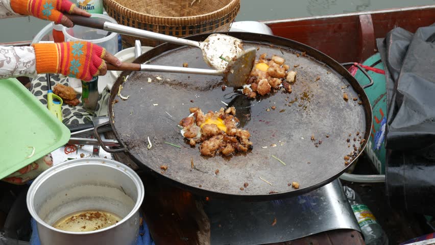 Selling food in floating market, Thailand