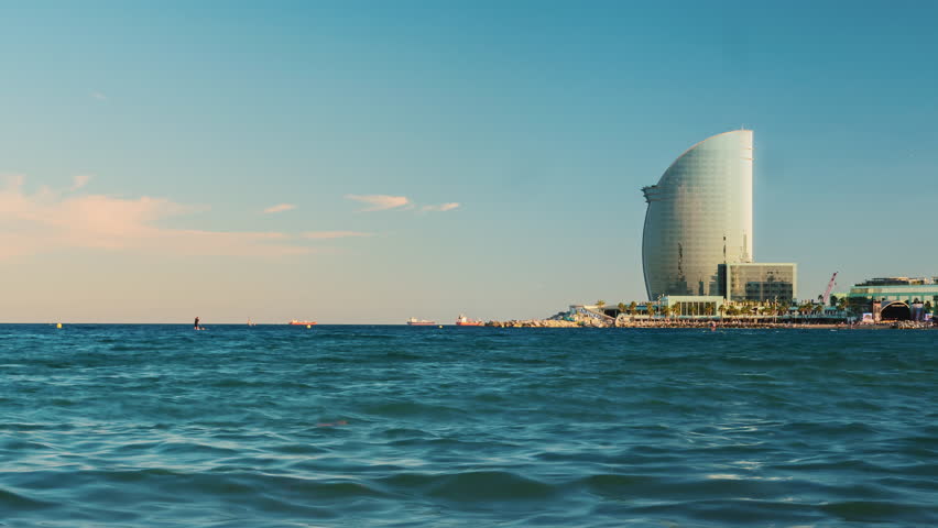 Seafront of Barcelona. The traffic of ships and aircraft. Timelapse. The huge flow of tourists coming into the city, heavy traffic in the port