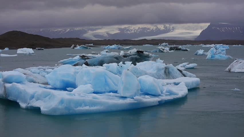 Floating of blue icebergs in Jokulsarlon glacial lagoon in the white nights. Vatnajokull National Park, southeast Iceland, Europe. Full HD video (High Definition). 
