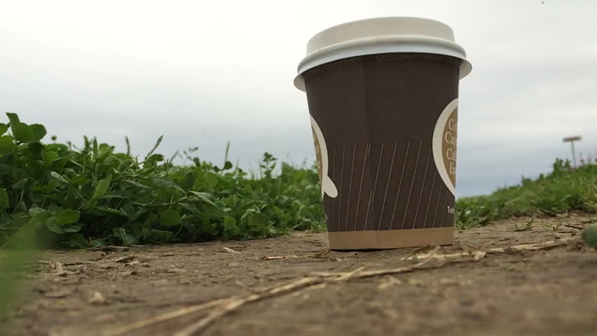 sledge hammer hit on the paper cup on the ground in slow motion