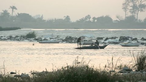 Fisher Man Fishing with his boat in Egypt Nile at AlQanatir in Early Morning 