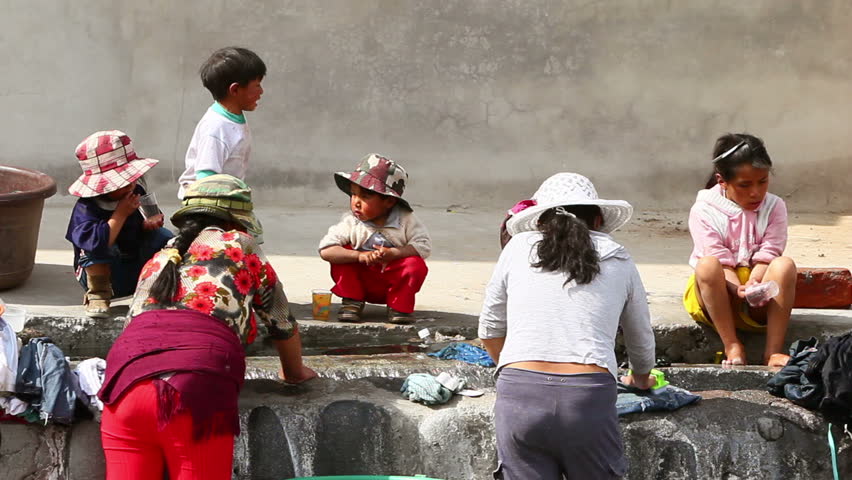 AMBATO, ECUADOR - CIRCA NOVEMBER 2011: People washing their clothing on the