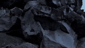 Rocky terrain land with volcanic minerals tracking video background