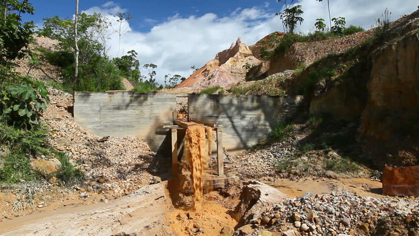 Water with high content of gold particles flowing through an artisanal piping system in Ecuador, Santiago Morona province