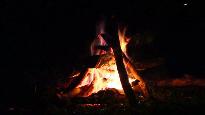 camp fire burning into the night