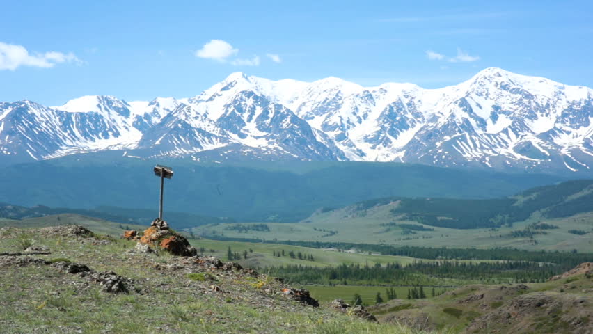 Girl climbs the hill and admiring the opening view of the mountains.