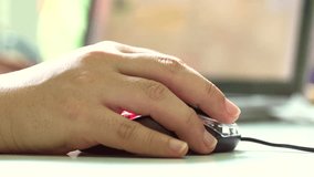 Female Hand Using a Computer Mouse ,with laptop screen  background. Ultra HD 3840x2160 Video Clip