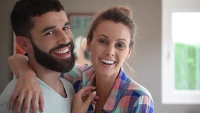 Cheerful hipster couple embracing each other