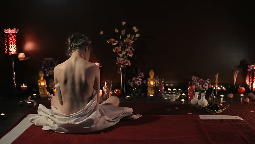 Stripped woman sits and looks around.