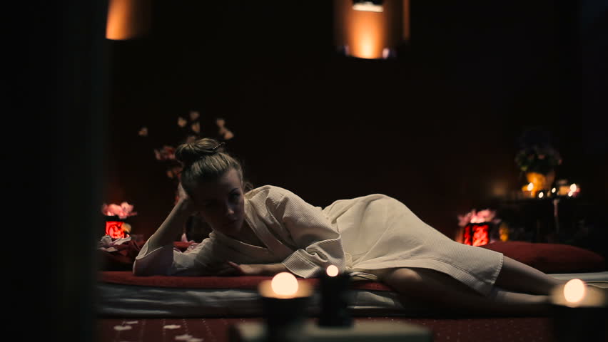 The woman lies on a massage table.